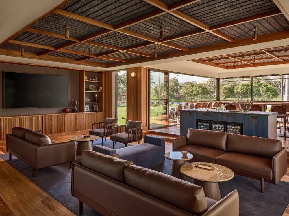 The Founders Club lounge: leather sofas, the bar and the pitch beyond